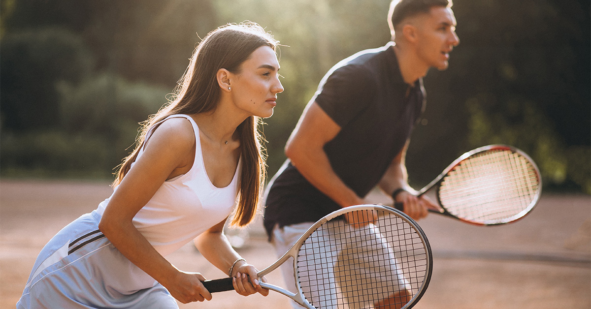 A couple enjoying a game of tennis together.