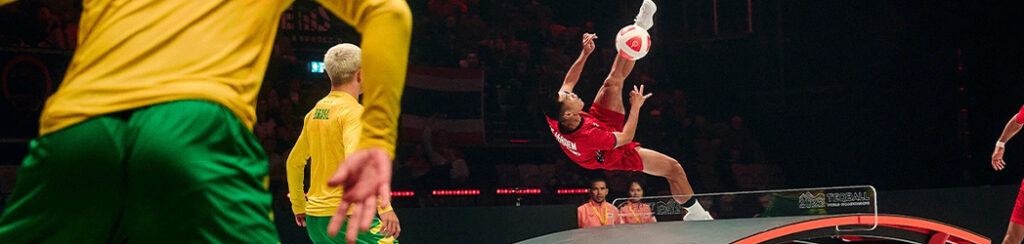 Teqball player performing a gymnastic high kick volley.