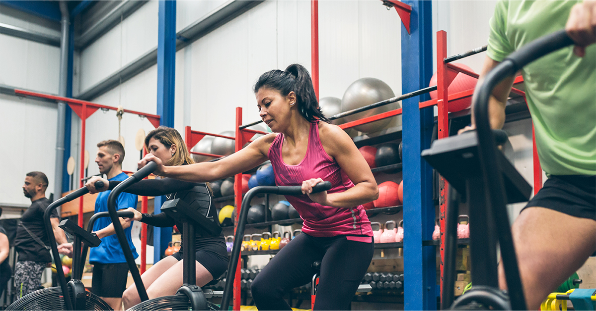 An intense cardio class with people using HIIT Bikes.