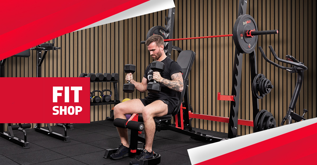 A person lifting dumbbells in a home gym setup.